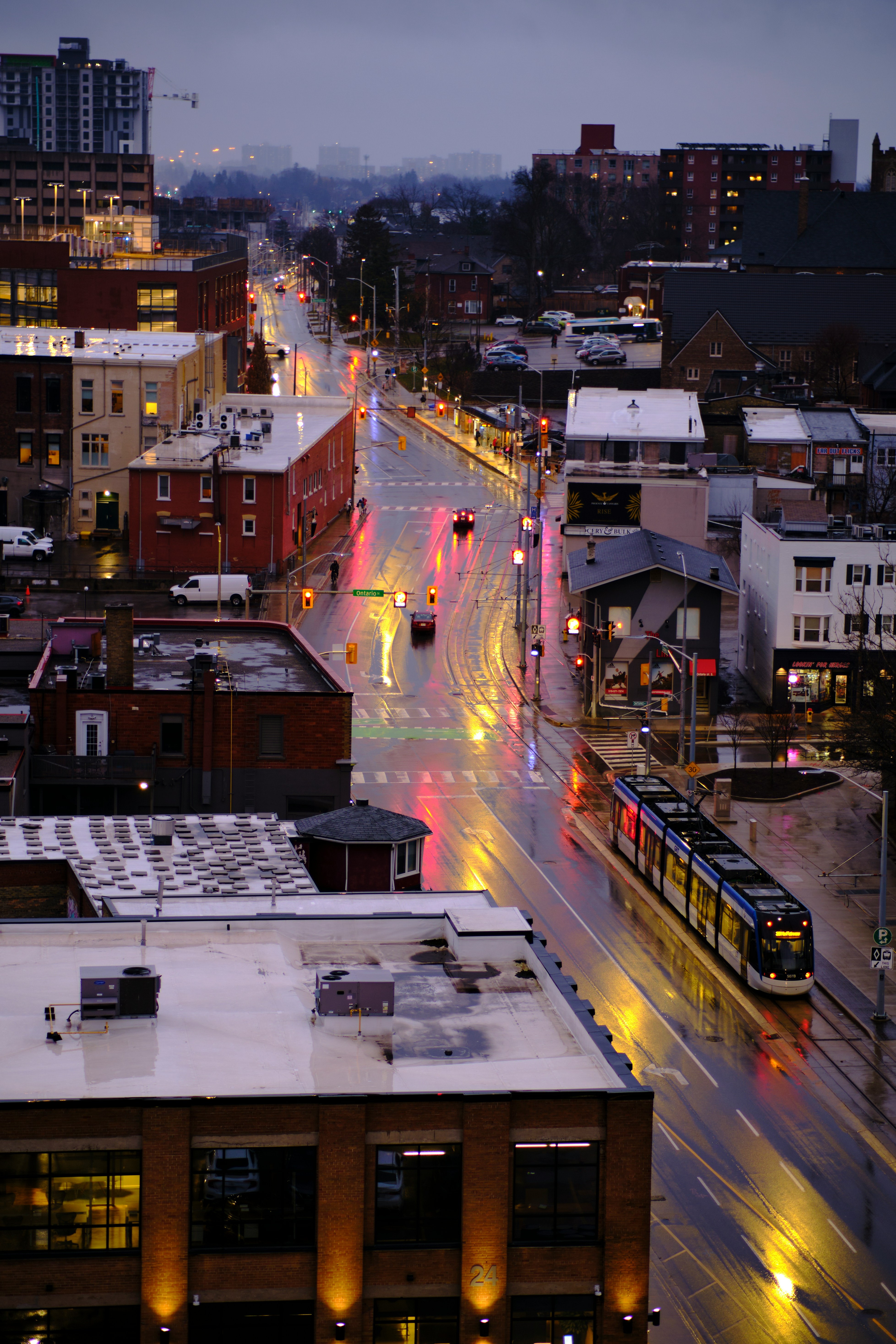 Aerial view of downtown Kitchener at dusk with ION light rail